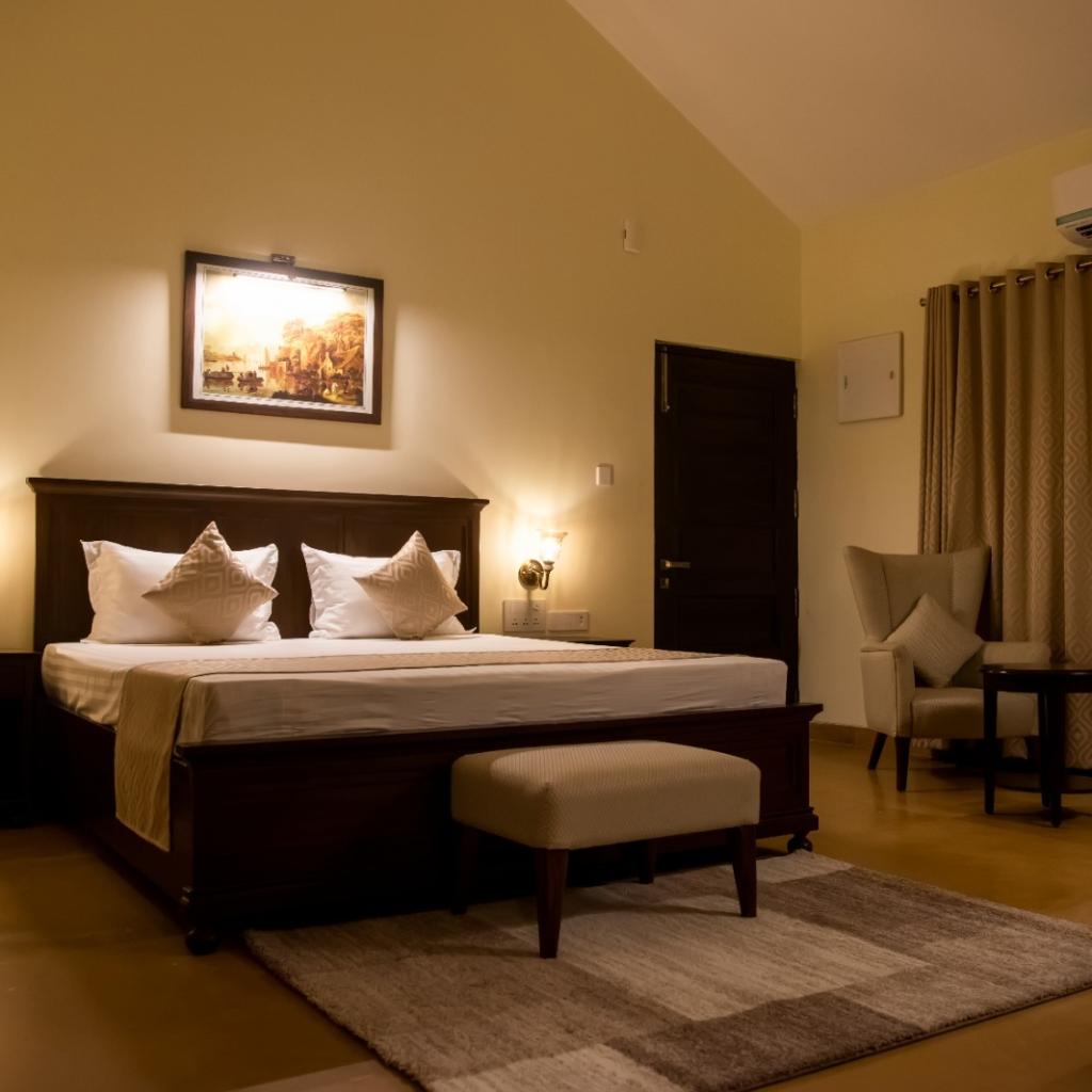 Luxury bedroom at Welcom Heritage Tadoba Vanya Villas with elegant decor and cozy ambiance.